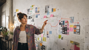 Creative business owner simplifying multiple marketing ideas into a clear 90-day business and marketing strategy.